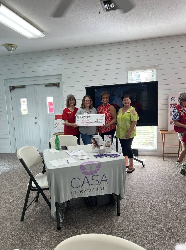 Members present a check to CASA, the Citrus Abuse Shelter