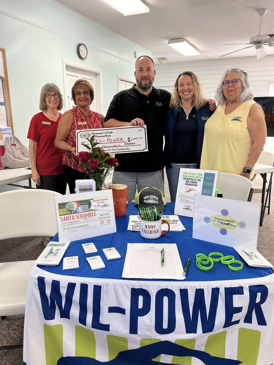 Club members present a check to the WIL-Power foundation at its table